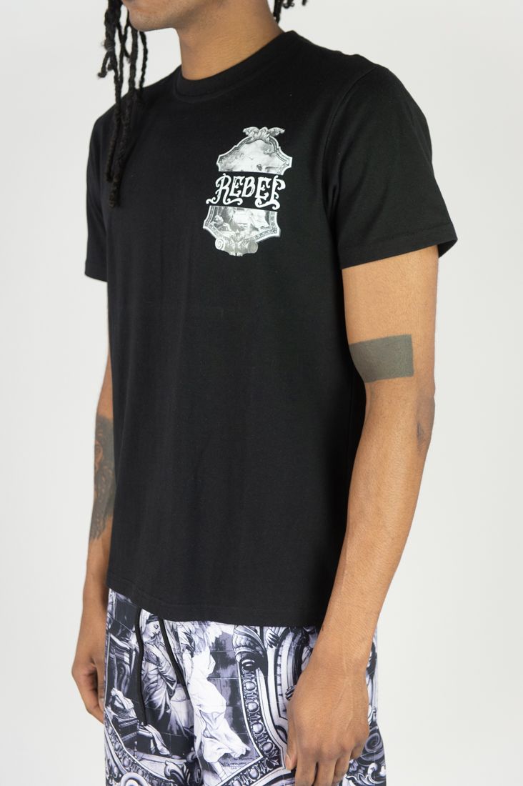 Person wearing a black t-shirt with a graphic design on a white background