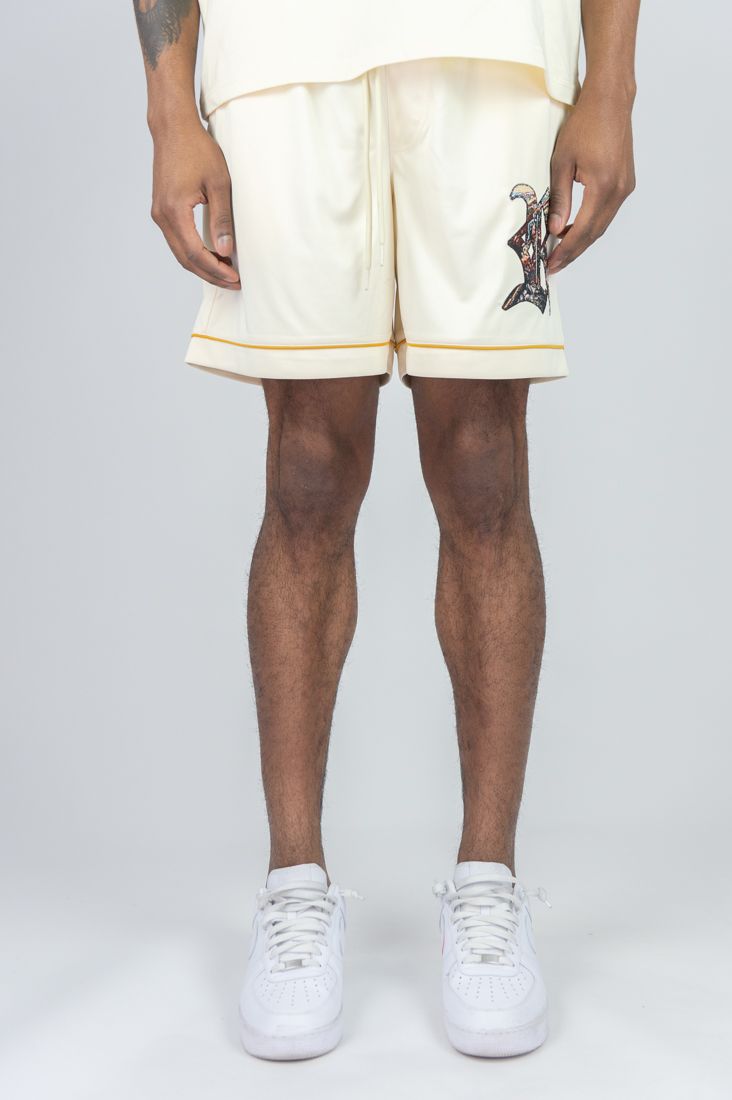 Person wearing cream shorts with a small graphic on a white background