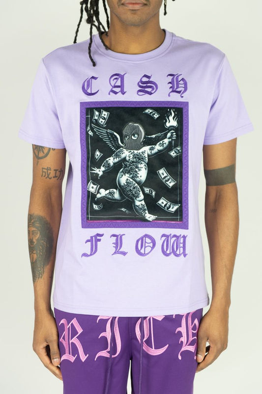 Person wearing a light purple t-shirt with a graphic design and text, standing against a plain background.