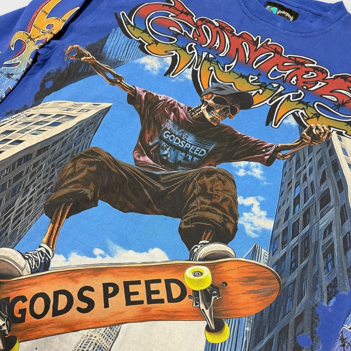 T-shirt with a graphic of a person on a skateboard and 'GODSPEED' text, set against a cityscape background.