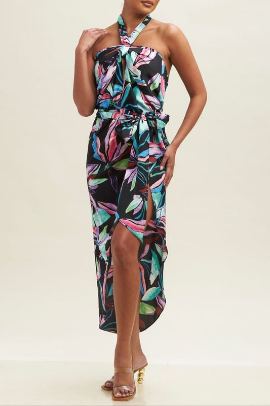 Woman wearing a colorful floral dress on a beige background