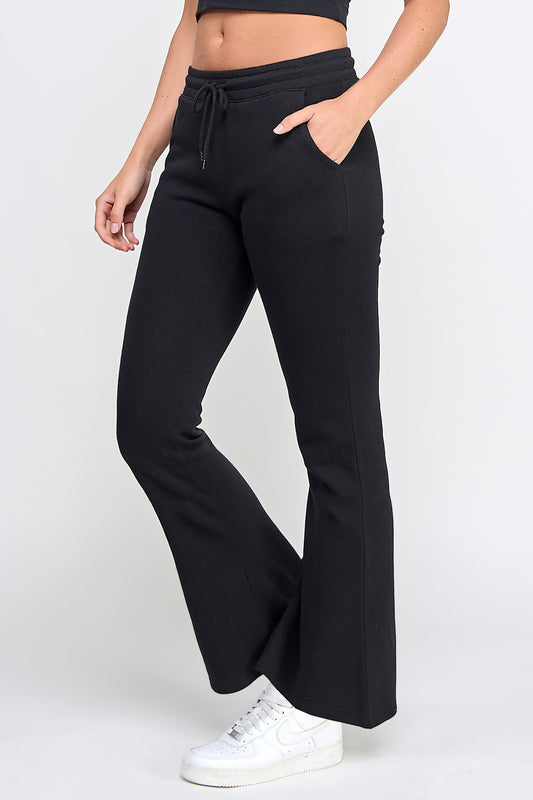 Black wide-leg pants worn by a person on a white background