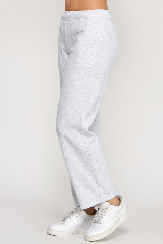 Light gray sweatpants worn by a person on a plain background