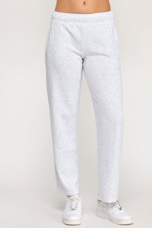 Gray sweatpants worn by a person on a plain background