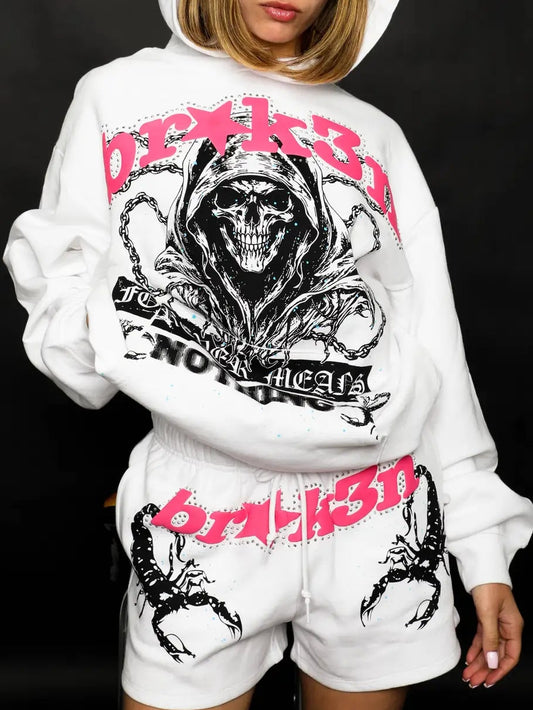 Person wearing a white hoodie and shorts with graphic designs and text on a black background