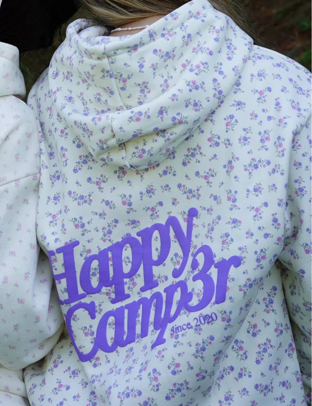 Floral-patterned hoodie with 'Happy Camper' text on a floral background
