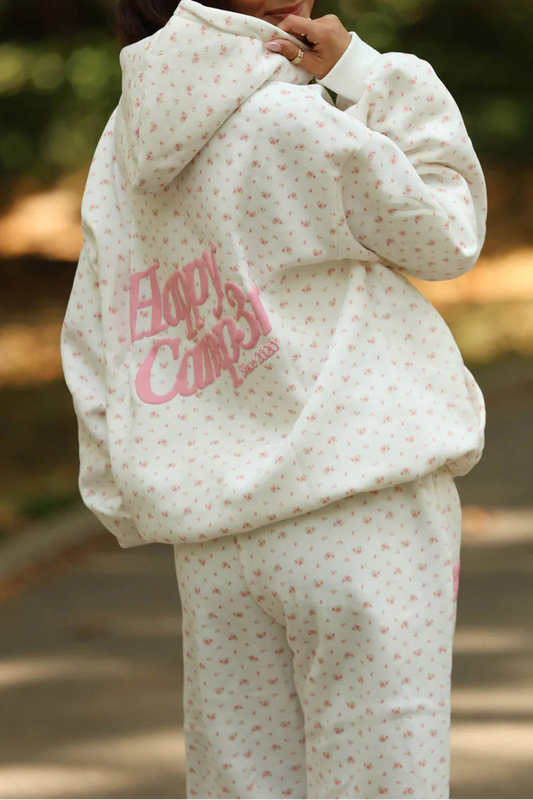 Person wearing a white outfit with pink text outdoors
