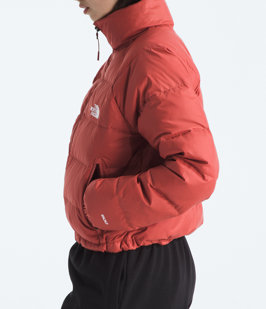 Person wearing a red jacket with a brand logo on a white background