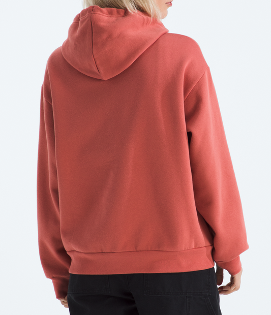 Person wearing a red hoodie and black cap on a white background