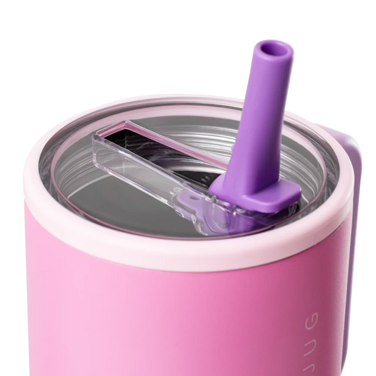 Pink tumbler with a purple straw lid on a white background