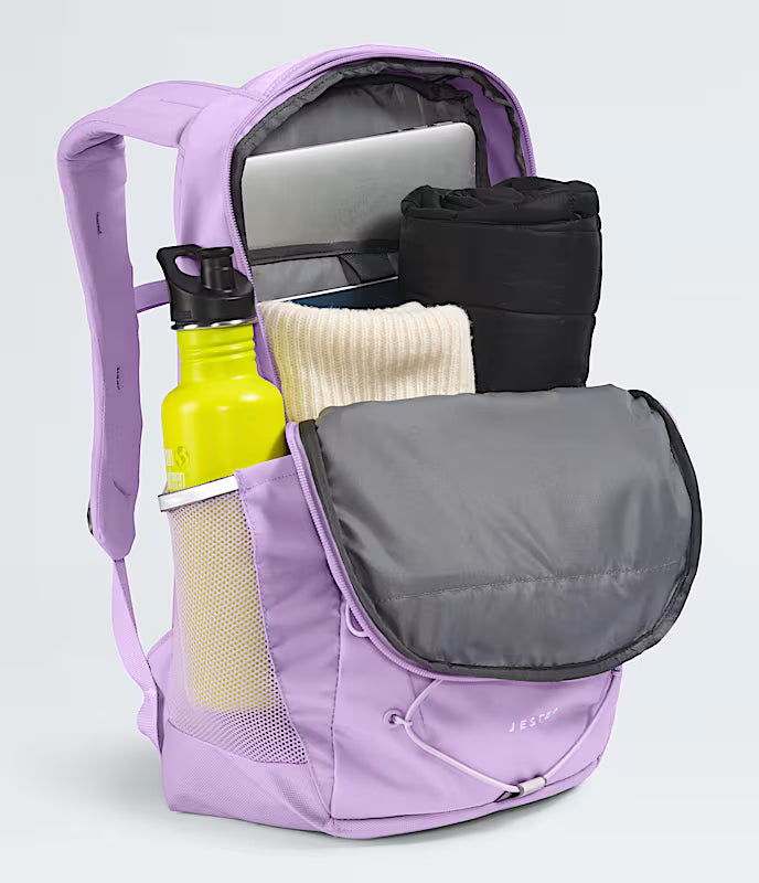 Purple backpack with various items including a yellow water bottle and black bag on a light gray background