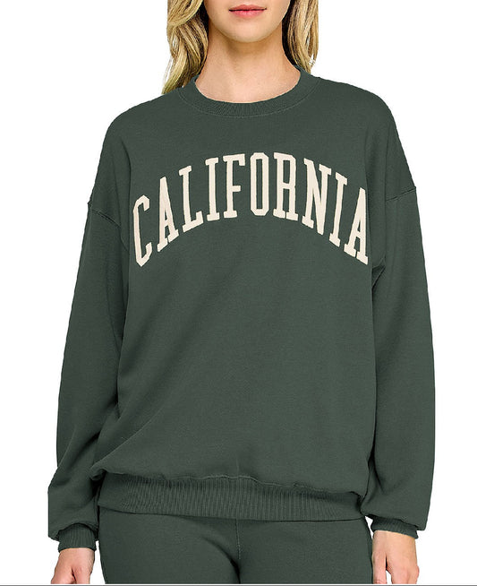 Person wearing a green sweatshirt with 'California' printed on it against a white background