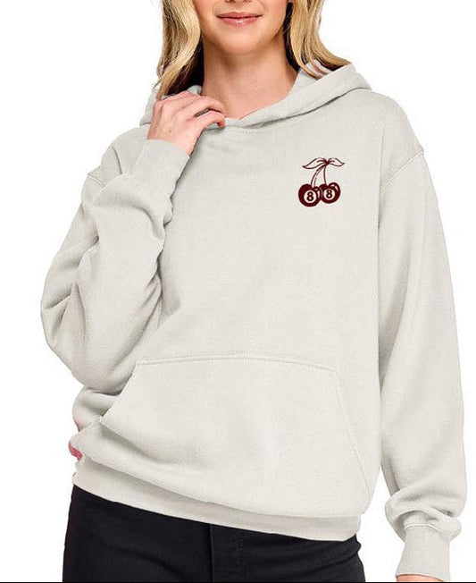 Woman wearing a light gray hoodie with a logo on a white background