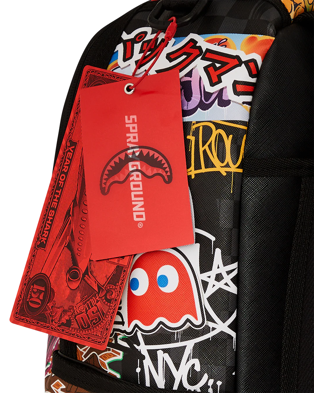 Backpack with colorful graphics and a red 'Sprayground' tag.