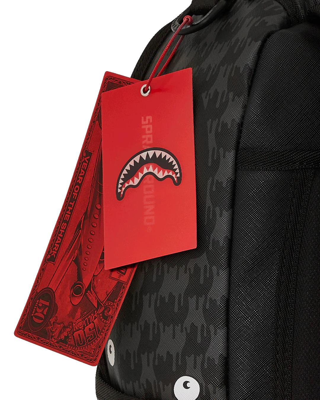 Black backpack with red tags featuring a shark logo on a white background