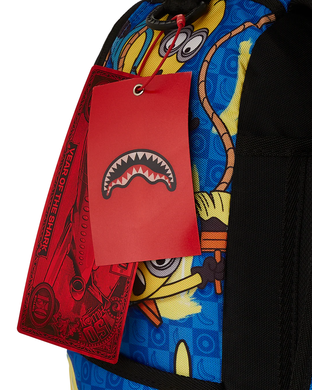 Colorful backpack with a red tag featuring a shark design on a white background