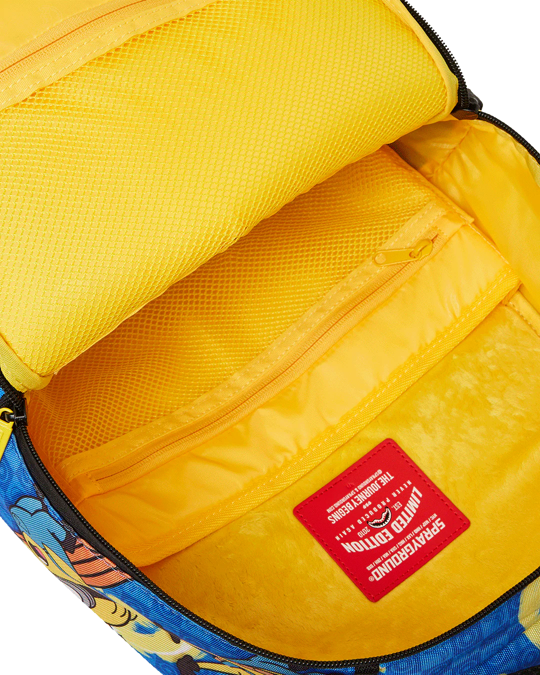 Yellow interior of a backpack with a colorful design and a red label.