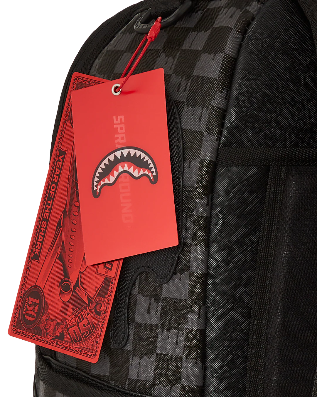 Black checkered backpack with a red tag featuring a shark logo on a white background