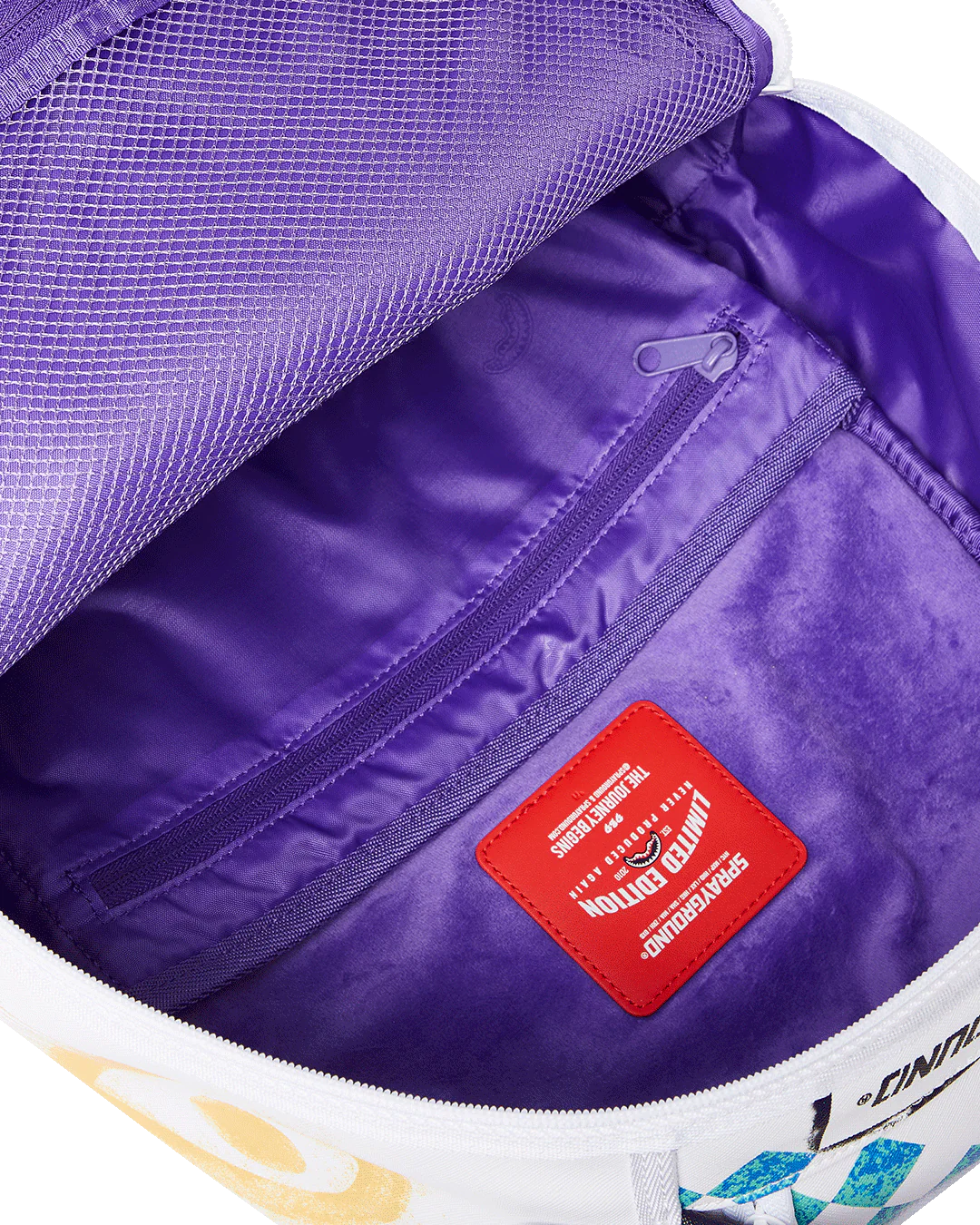 Close-up of a purple bag with a red label and visible brand logo.