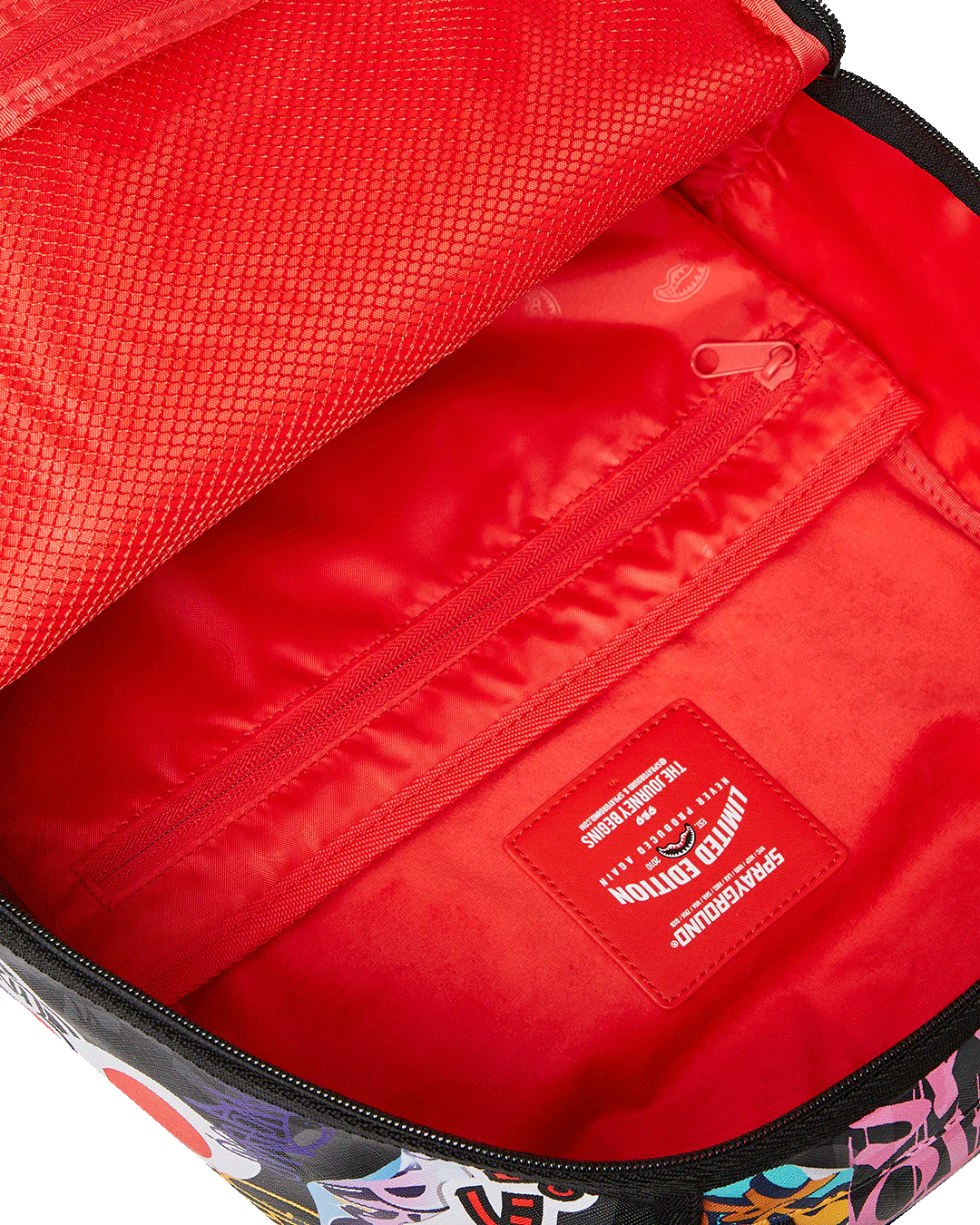 Close-up of a red bag interior with a visible brand logo.