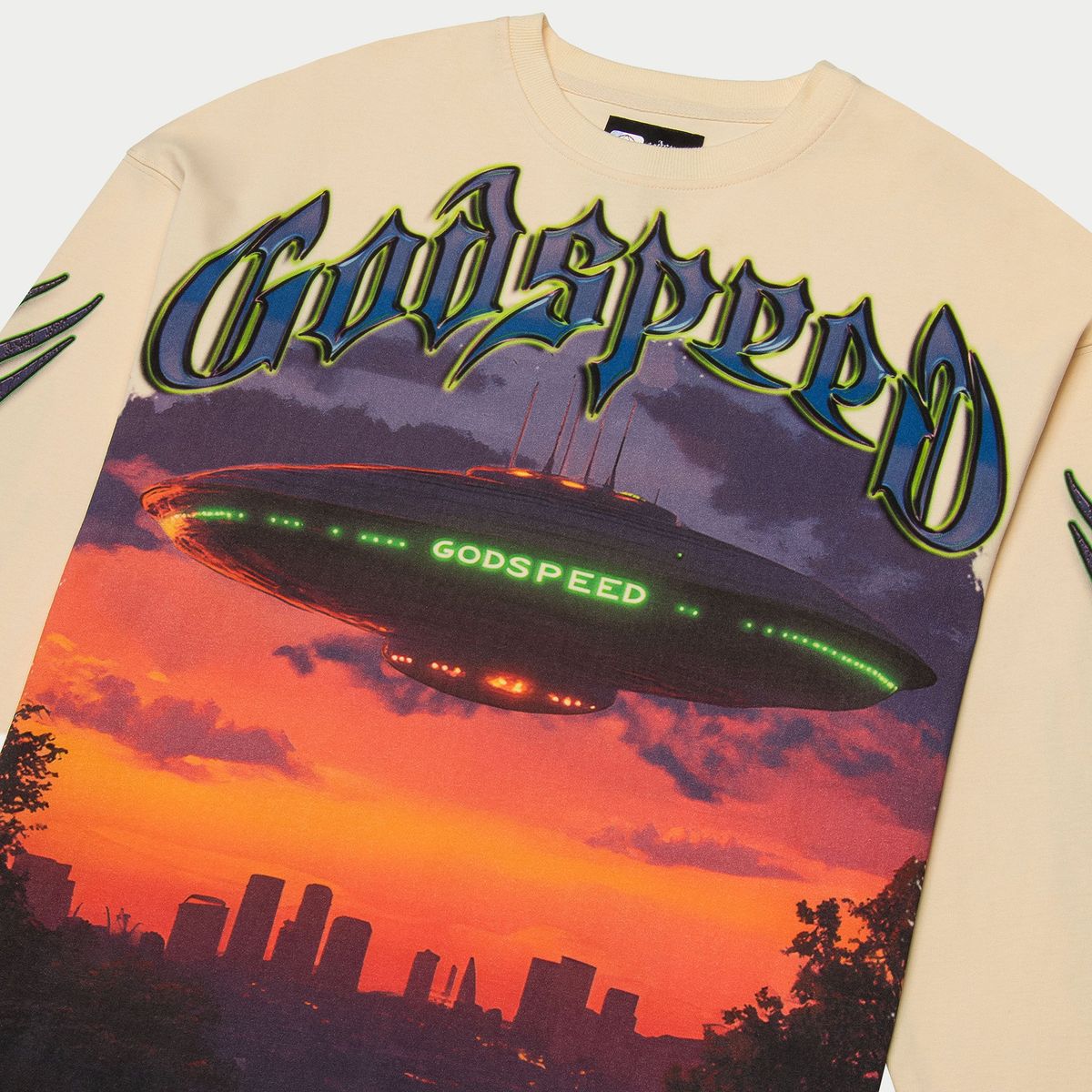 Beige sweatshirt with 'Godspeed' design featuring a UFO and cityscape.