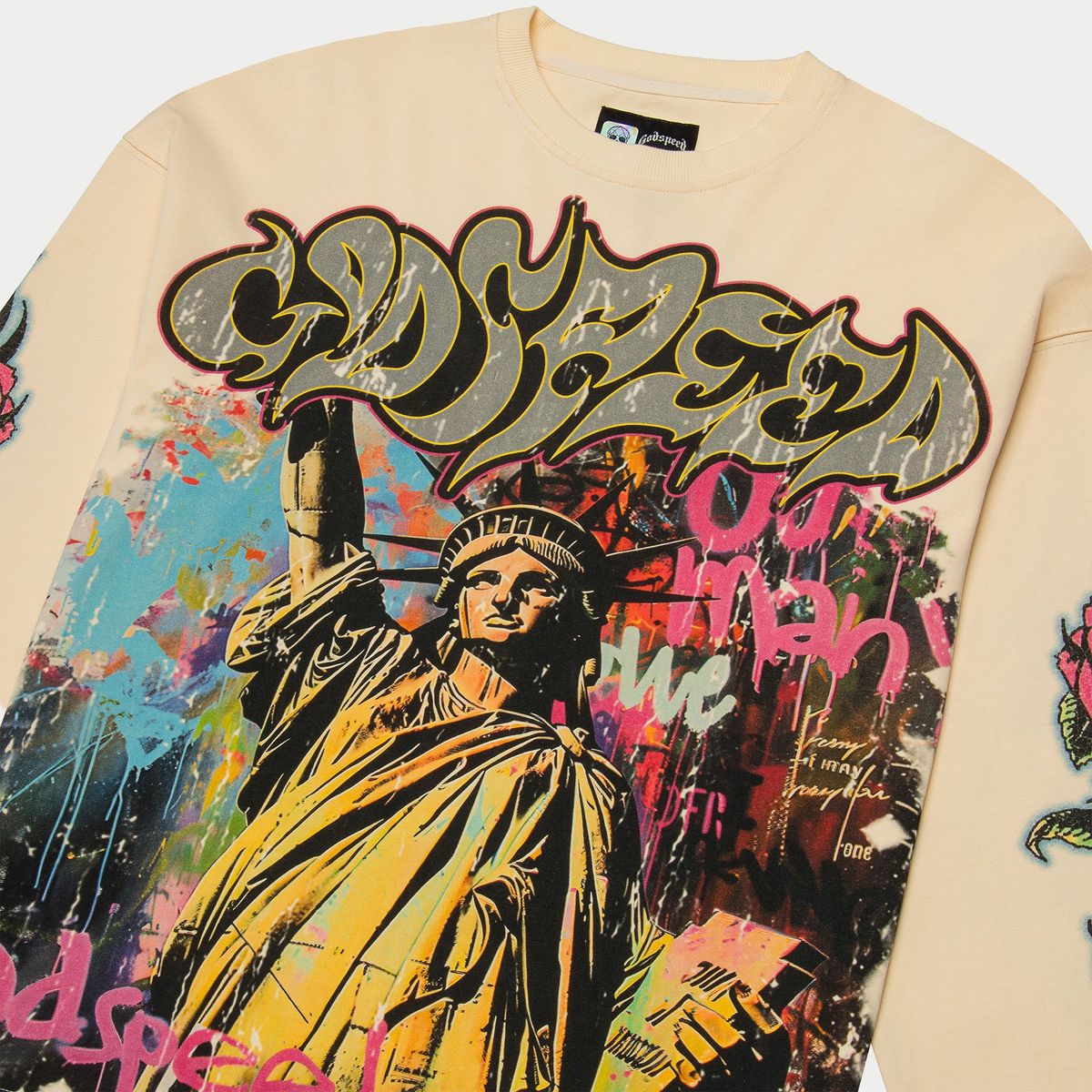 Beige sweatshirt with colorful graphic design featuring the Statue of Liberty and abstract elements.