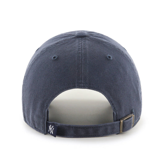 A navy blue baseball cap with a "NY" logo in white on the front and strap, featuring a metal clasp and subtle stitching details.