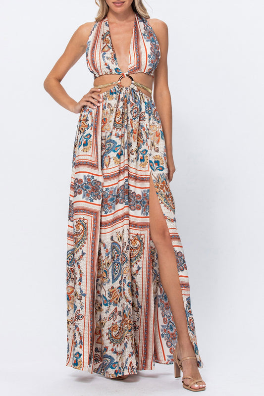 Woman wearing a floral patterned dress with a high slit on a white background