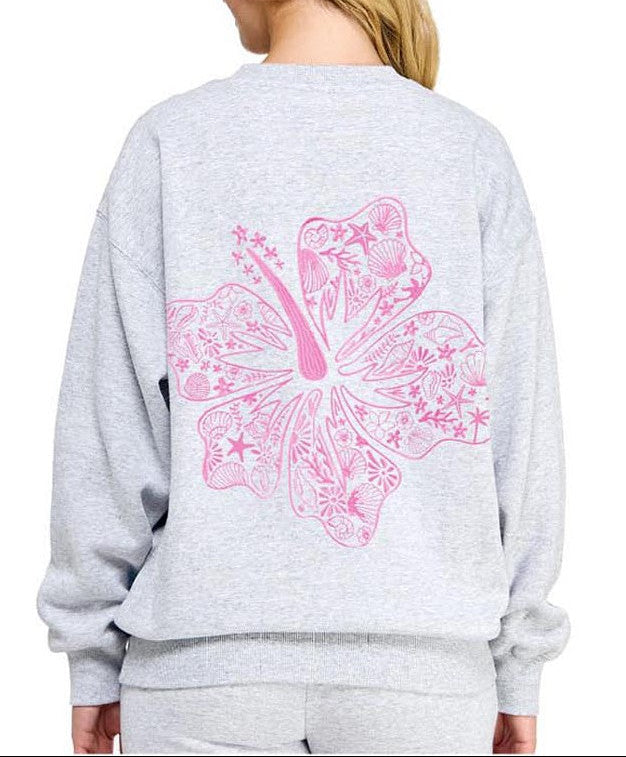 Gray sweatshirt with a pink butterfly design on the back, worn by a person.