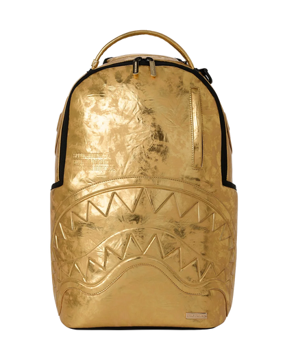 Gold metallic backpack with a shark mouth design on a white background