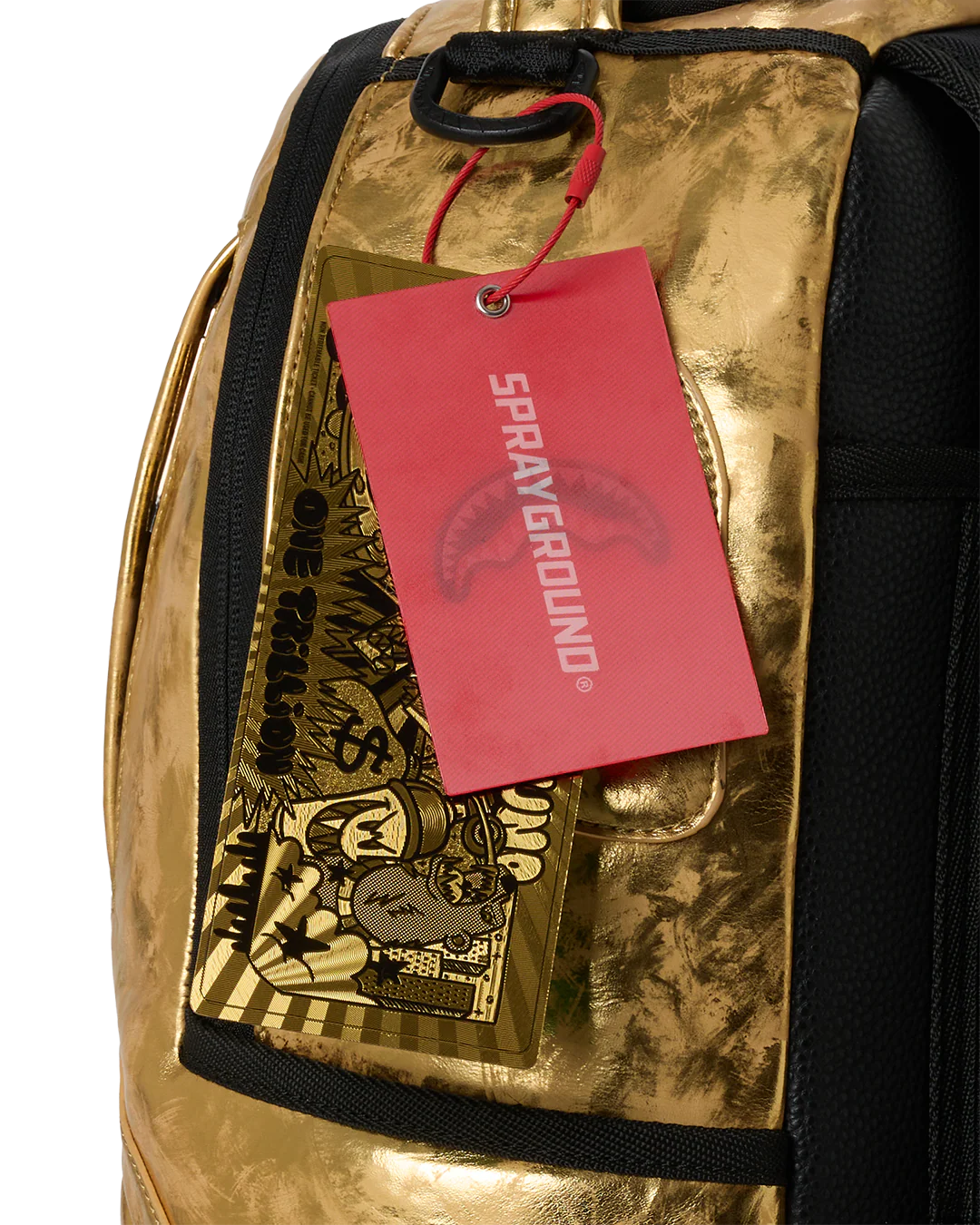 Gold metallic backpack with a red 'Sprayground' tag