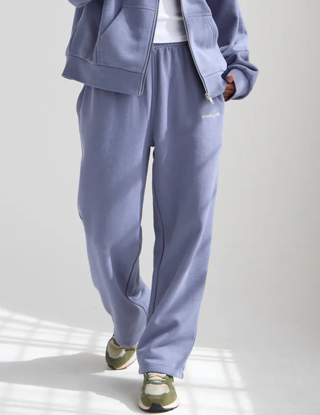 Person wearing a light blue tracksuit on a white background
