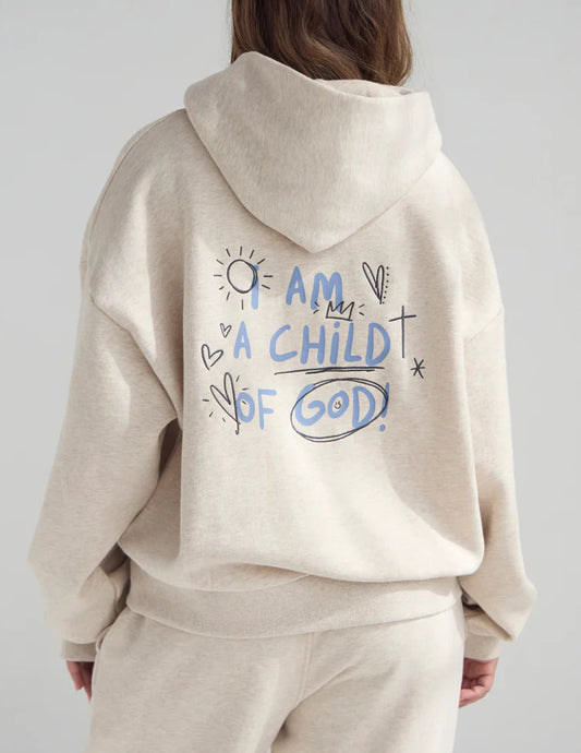 Person wearing a beige hoodie with 'I am a child of God' text on the back against a plain background
