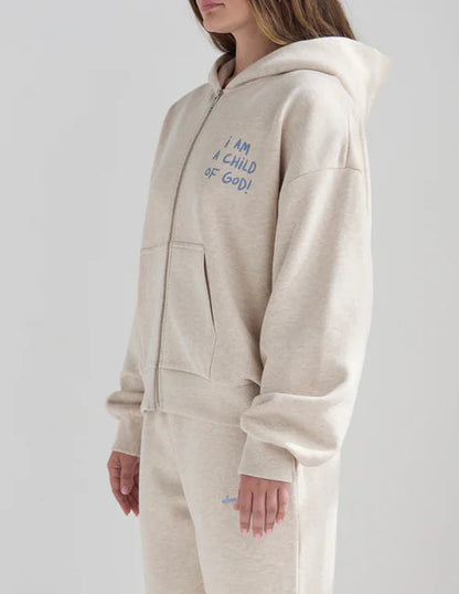 Person wearing a beige onesie with text on a plain background
