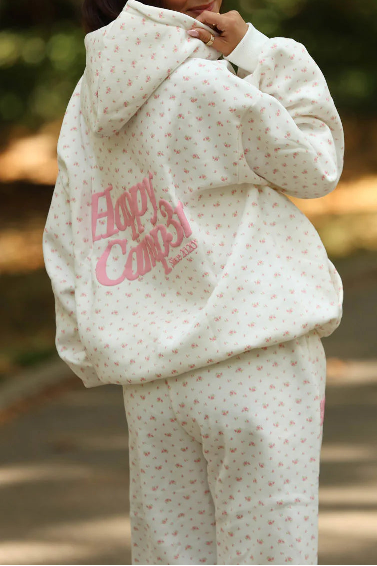 Person wearing a white outfit with pink text outdoors
