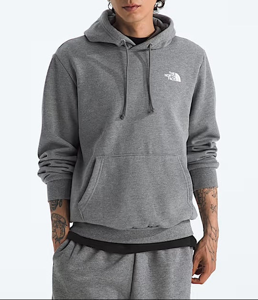 Person wearing a gray hoodie with a brand logo on a white background