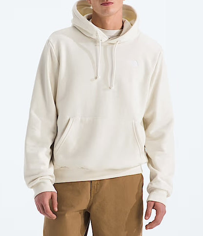 Man wearing a beige hoodie and brown pants on a white background 