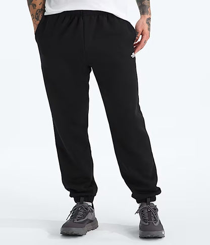 Person wearing black sweatpants on a white background