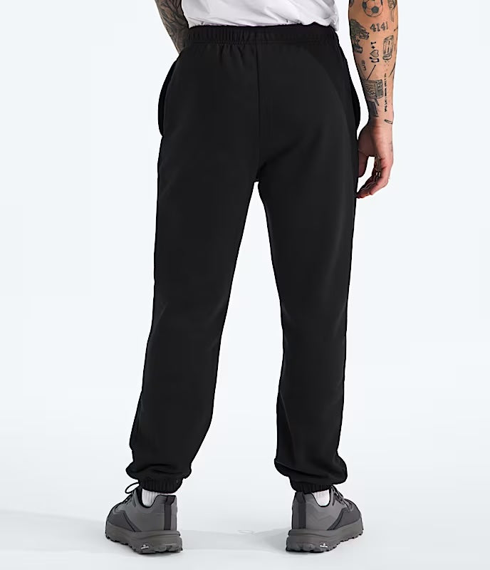 Person wearing black sweatpants on a white background