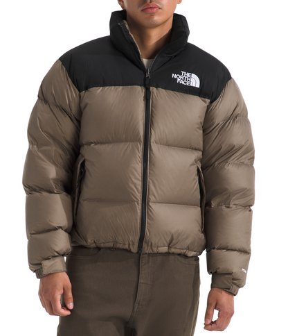 Person wearing a brown and black puffer jacket with 'The North Face' logo on a white background