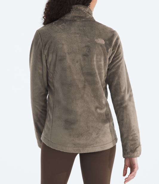 Person wearing a brown fleece jacket with a visible brand logo on a white background