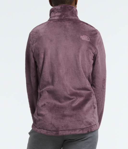 Person wearing a purple jacket with a brand logo on the back against a white background