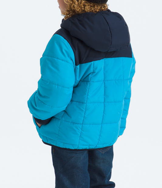 Child wearing a blue and black jacket on a white background