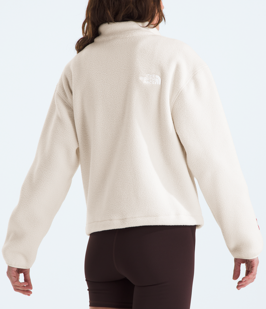 Person wearing a beige fleece jacket with a visible brand logo on a white background