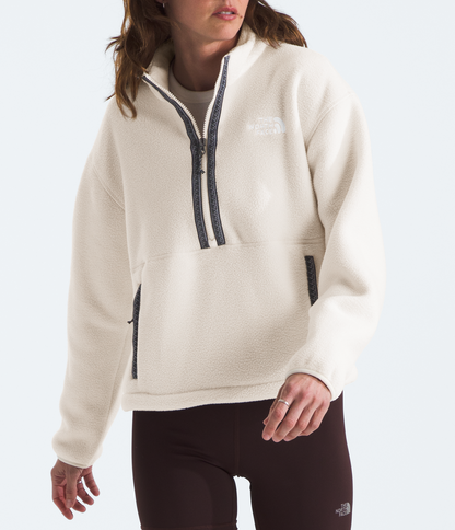 Woman wearing a white fleece pullover with a brand logo on a white background