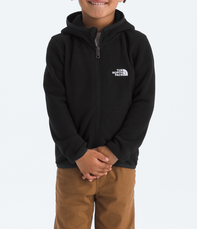 Child wearing a black hoodie with a logo and brown pants on a white background
