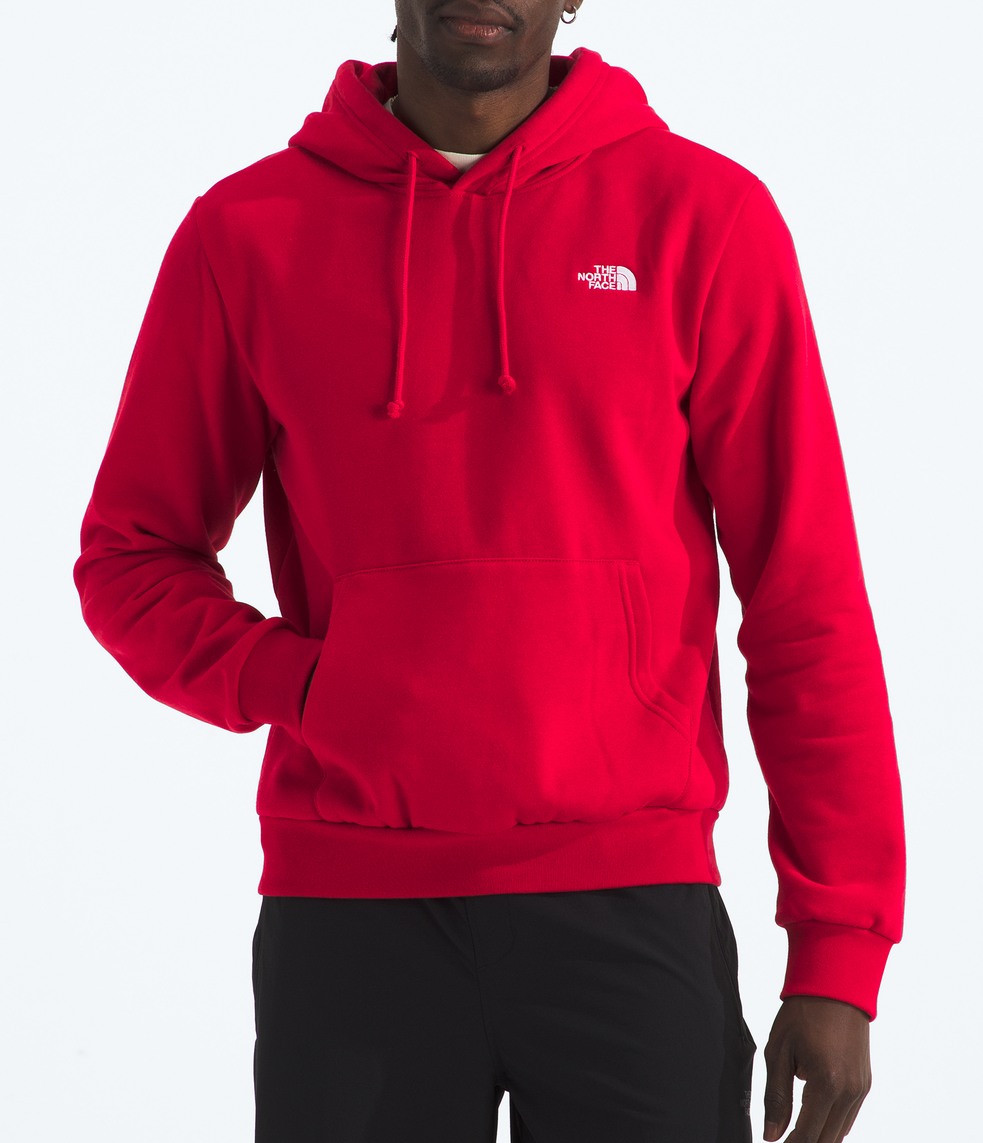 Person wearing a red hoodie with a logo on a white background 