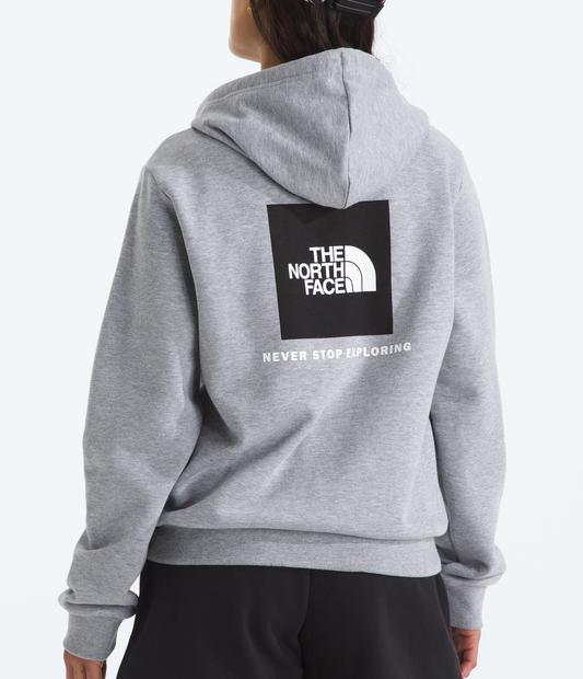 Person wearing a gray hoodie with The North Face logo on the back, standing against a white background.