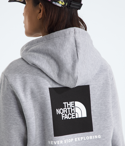 Person wearing a gray hoodie with The North Face logo on the back