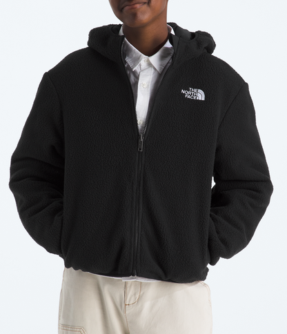 Person wearing a black The North Face jacket on a white background
